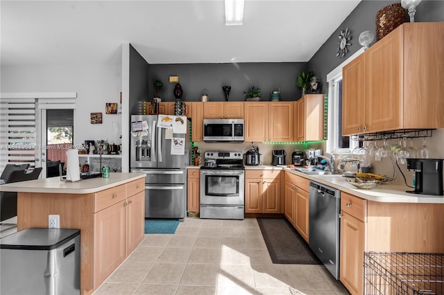 kitchen with sink, light brown cabinets, stainless steel appliances, and a healthy amount of sunlight