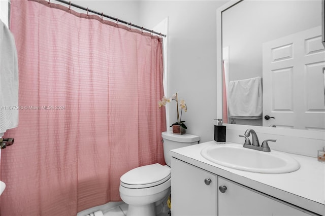 bathroom with vanity, a shower with curtain, toilet, and tile patterned floors