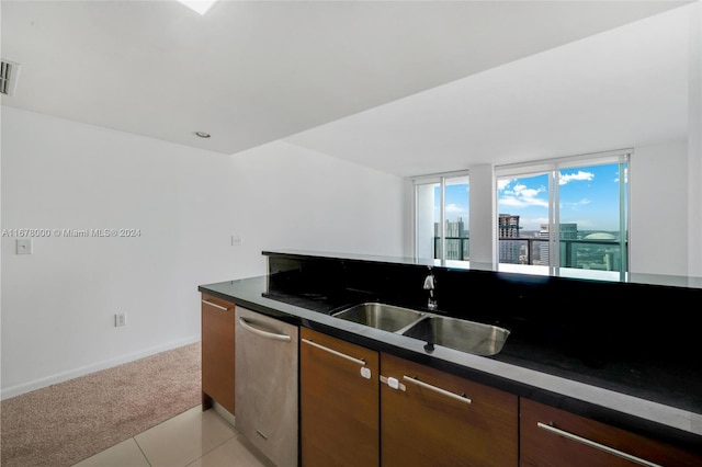 kitchen with dishwasher, sink, and light tile patterned flooring