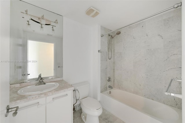 full bathroom featuring vanity, tiled shower / bath combo, and toilet