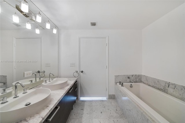 bathroom with tiled bath and vanity