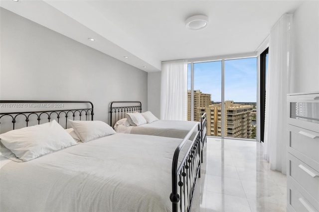 bedroom featuring light tile patterned flooring and floor to ceiling windows