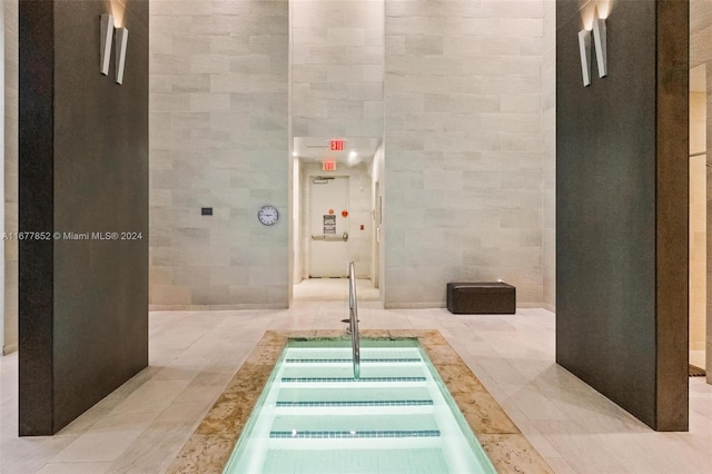 interior space featuring tile walls and tile patterned flooring