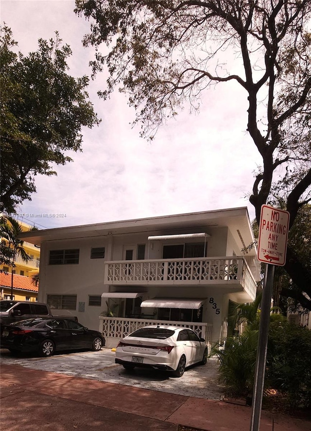 view of front of house featuring a balcony