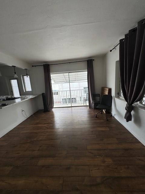 unfurnished living room with dark hardwood / wood-style flooring