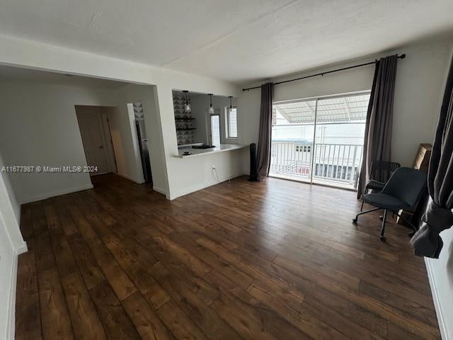 unfurnished living room featuring dark hardwood / wood-style floors