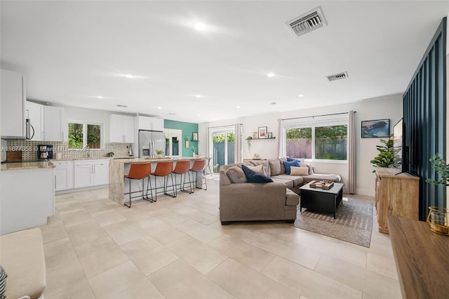 tiled living room featuring sink