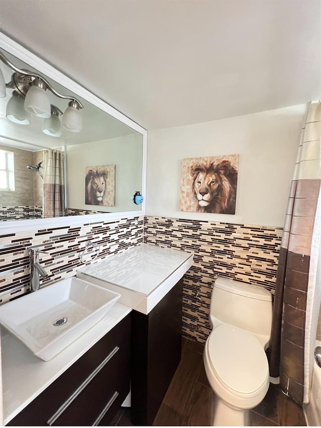 bathroom featuring toilet, walk in shower, and vanity