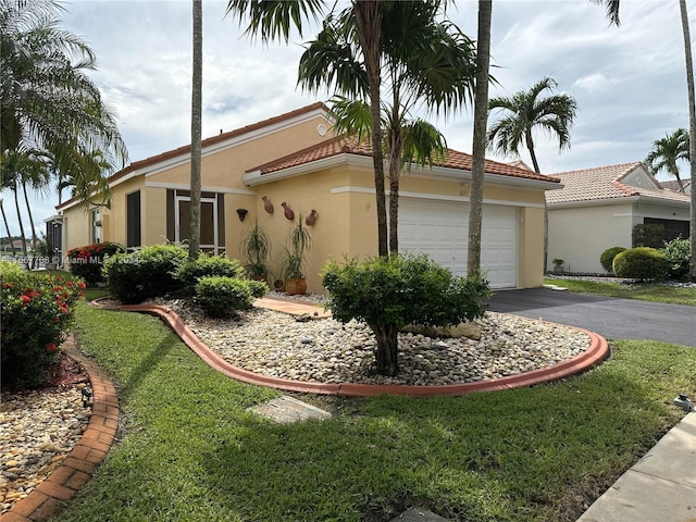 view of side of home featuring a garage and a lawn