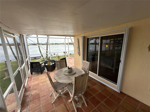 sunroom / solarium with a water view