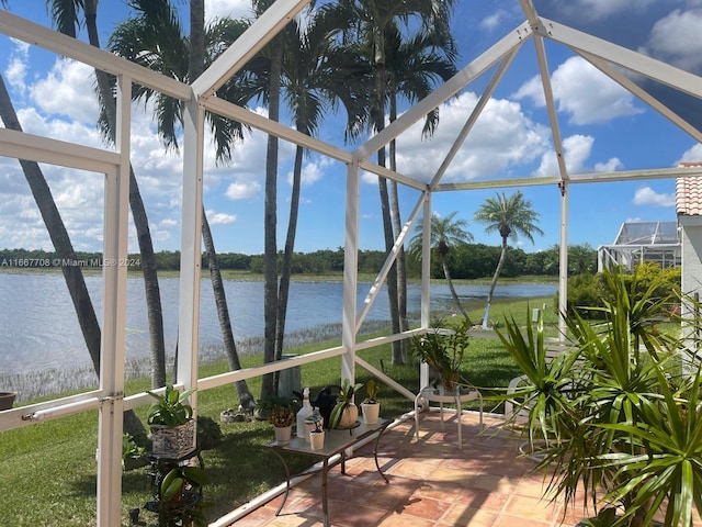 unfurnished sunroom with a water view