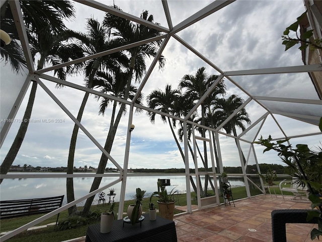 exterior space with a water view and a lanai