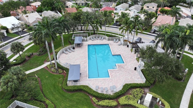 view of swimming pool featuring a patio and a lawn