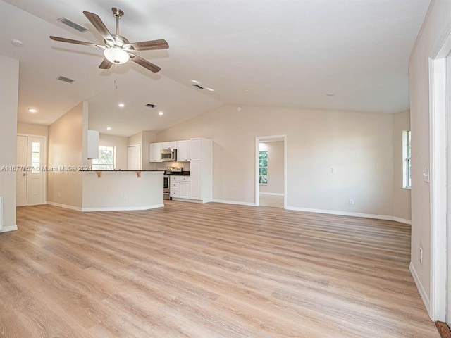 unfurnished living room featuring vaulted ceiling, light hardwood / wood-style flooring, and ceiling fan