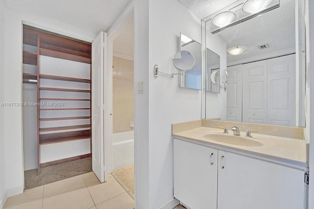 bathroom featuring vanity, a textured ceiling, and tile patterned floors