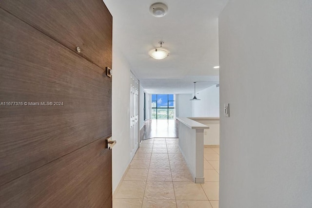 corridor featuring light tile patterned floors