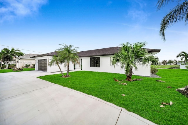 ranch-style house featuring a front yard and a garage