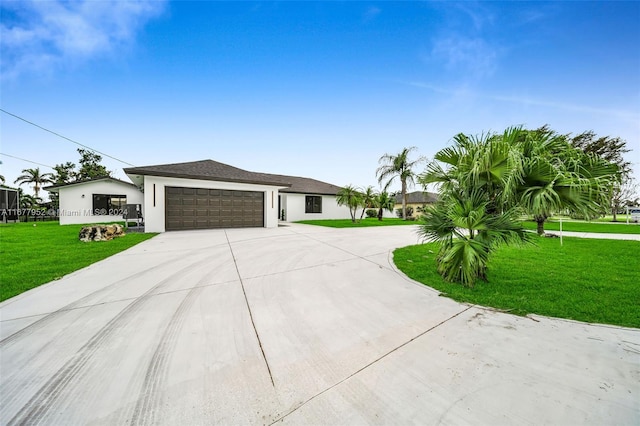 view of front of house with a front yard and a garage