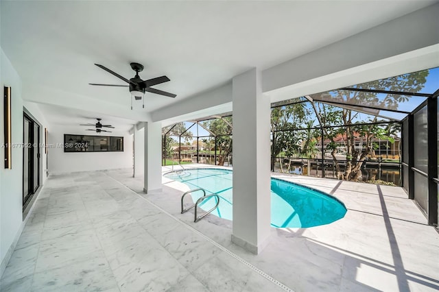 view of pool featuring glass enclosure, ceiling fan, and a patio area