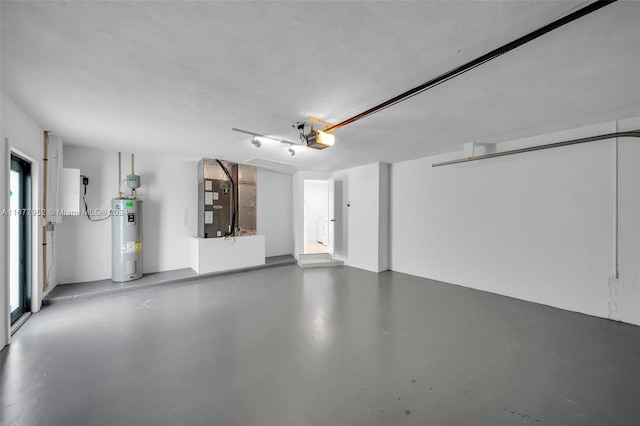 garage featuring heating unit, a garage door opener, and water heater