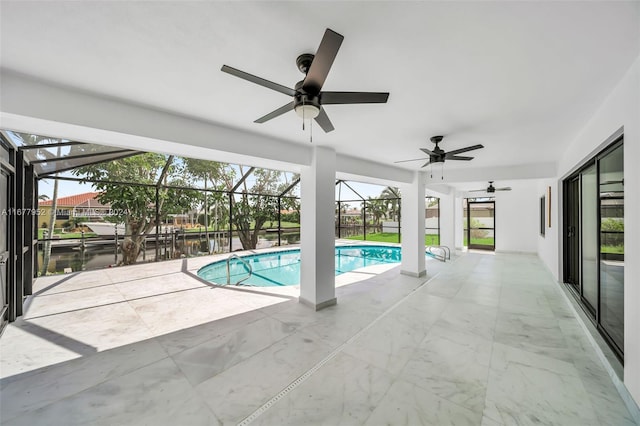 view of pool with glass enclosure, a water view, and a patio