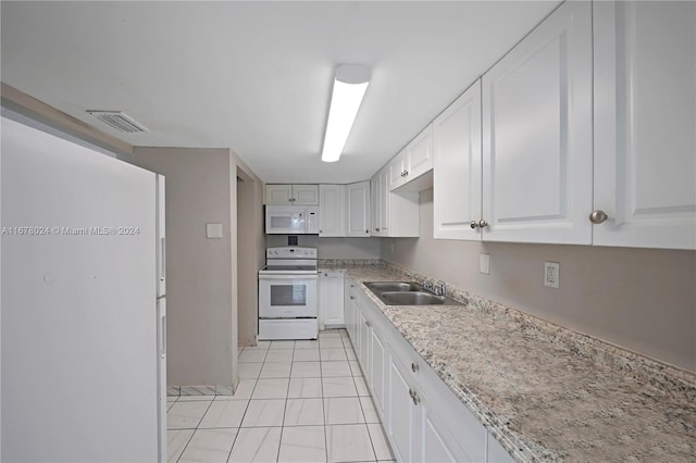 kitchen featuring white appliances, white cabinetry, and sink