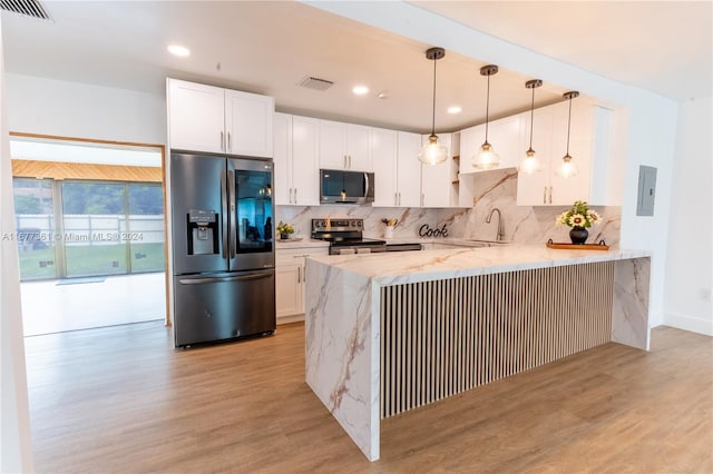 kitchen featuring kitchen peninsula, appliances with stainless steel finishes, light hardwood / wood-style floors, and white cabinetry