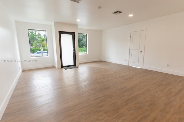 unfurnished room featuring a healthy amount of sunlight and light wood-type flooring