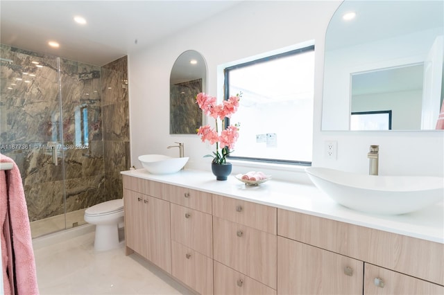 bathroom with walk in shower, a wealth of natural light, vanity, and toilet