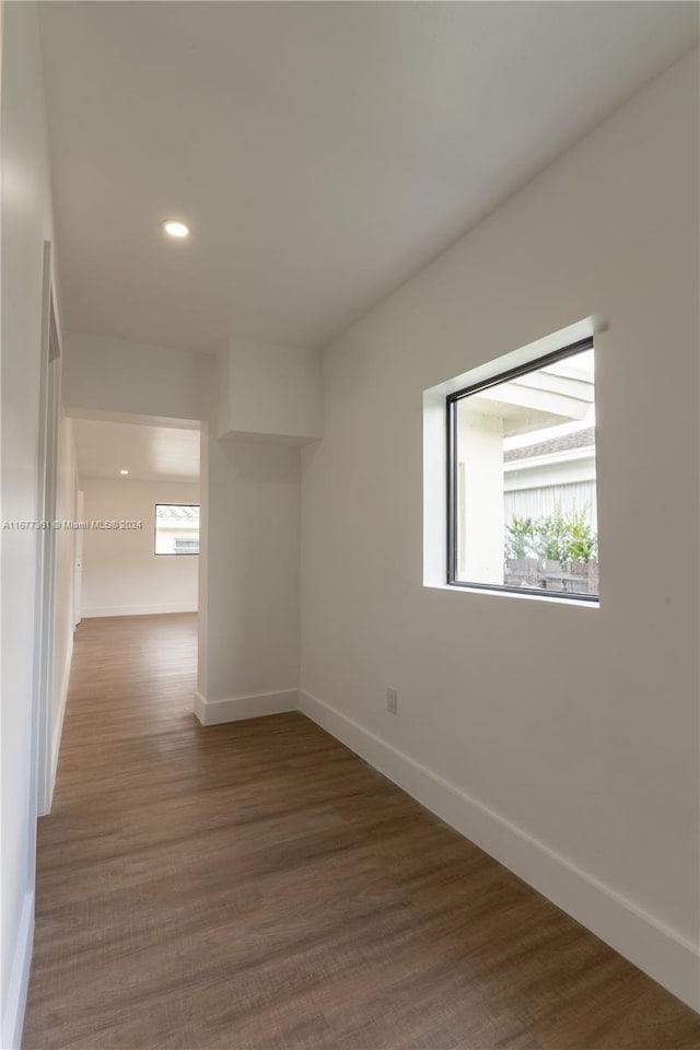 unfurnished room with dark wood-type flooring