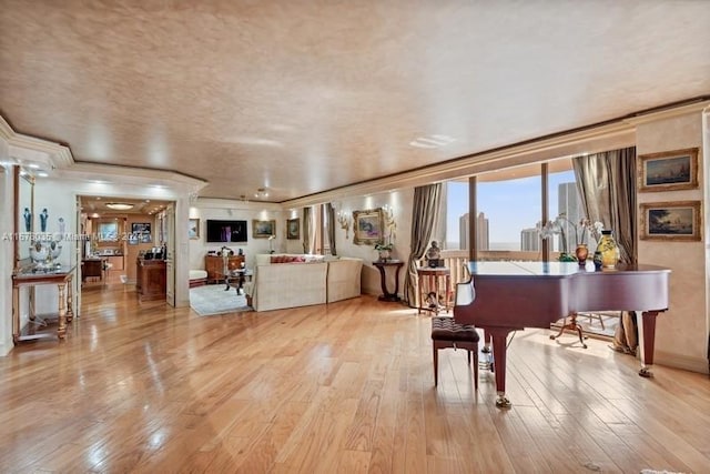 miscellaneous room featuring crown molding and light hardwood / wood-style flooring