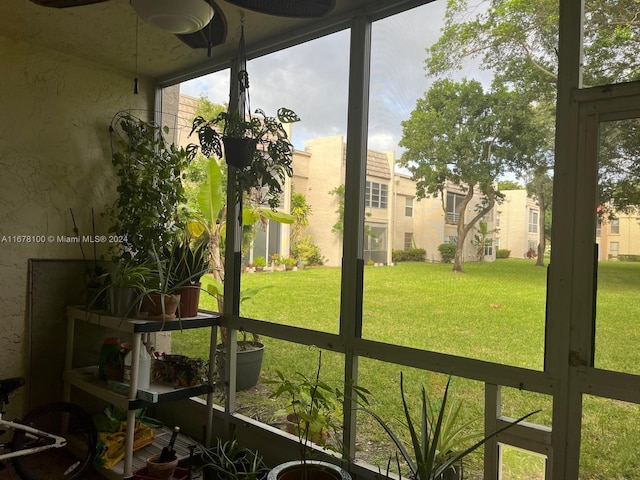 sunroom featuring ceiling fan and a healthy amount of sunlight