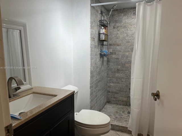 bathroom with toilet, a shower with curtain, vanity, and tile patterned flooring