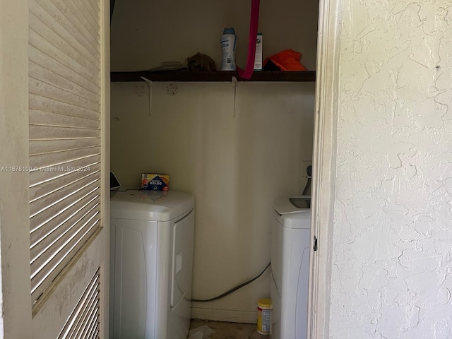 clothes washing area with washer and clothes dryer