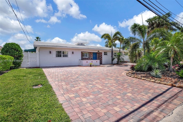 rear view of property featuring a patio area and a lawn