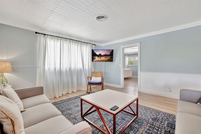 living room with ornamental molding and hardwood / wood-style flooring