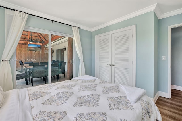 bedroom featuring a closet, ornamental molding, hardwood / wood-style flooring, and access to exterior