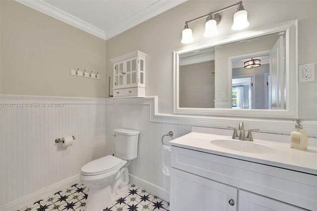 bathroom with toilet, ornamental molding, and vanity