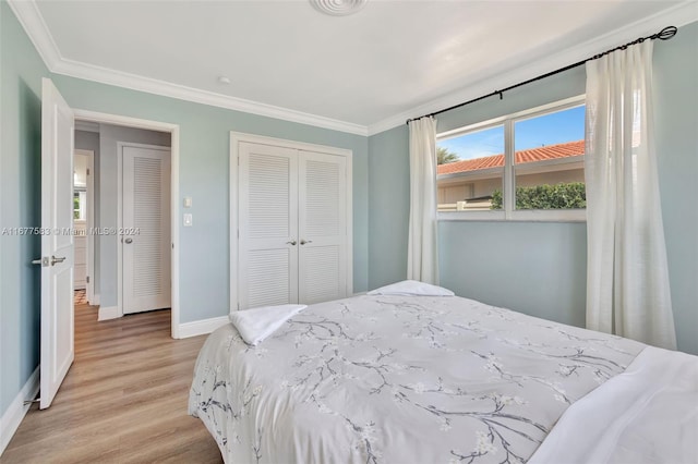 bedroom with ornamental molding and light wood-type flooring