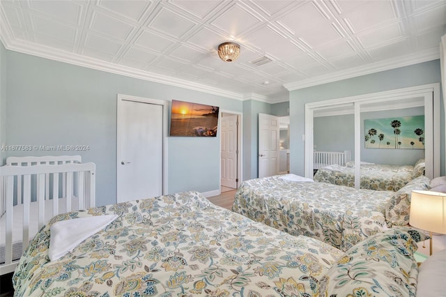 bedroom with crown molding and hardwood / wood-style floors