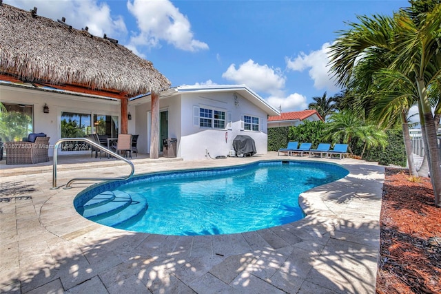 view of swimming pool with a patio area and an outdoor structure