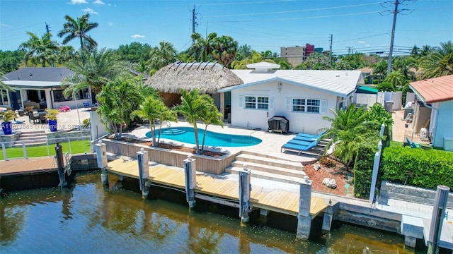 exterior space with a patio, a boat dock, a water view, and area for grilling