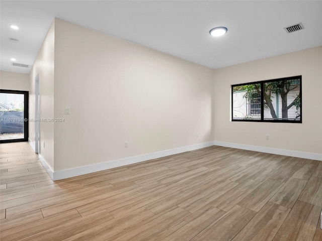 empty room featuring light wood-type flooring and a wealth of natural light