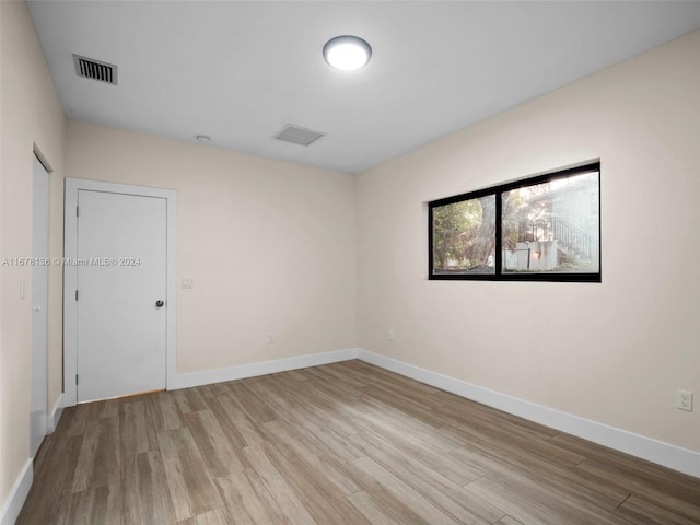 spare room featuring light hardwood / wood-style floors