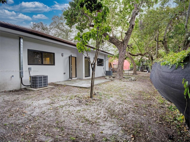 view of yard featuring a patio and central AC