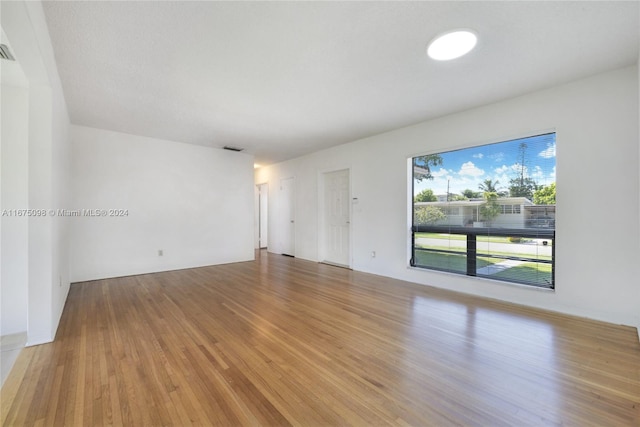 empty room with hardwood / wood-style flooring