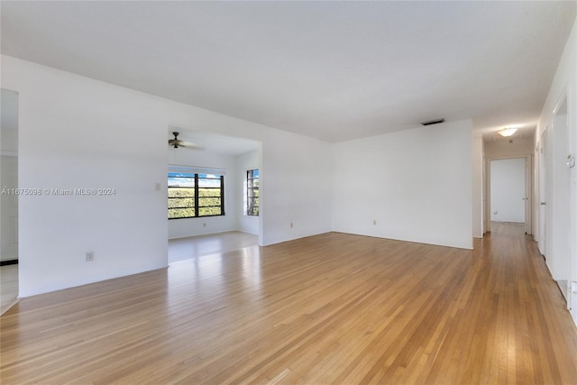 spare room featuring light wood-type flooring and ceiling fan