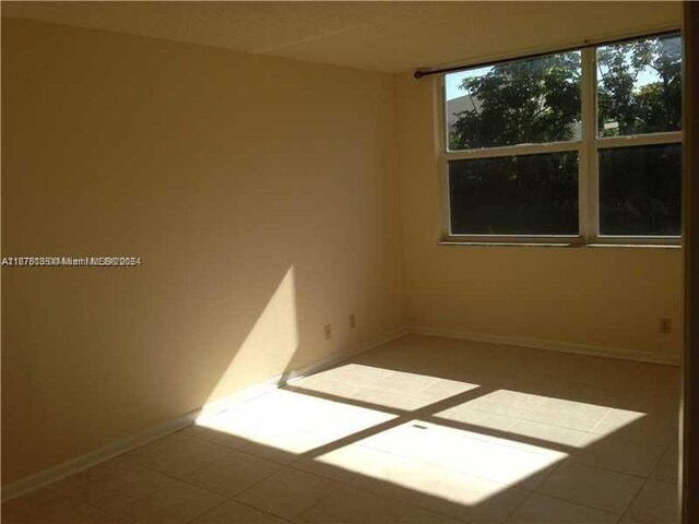 spare room with tile patterned flooring