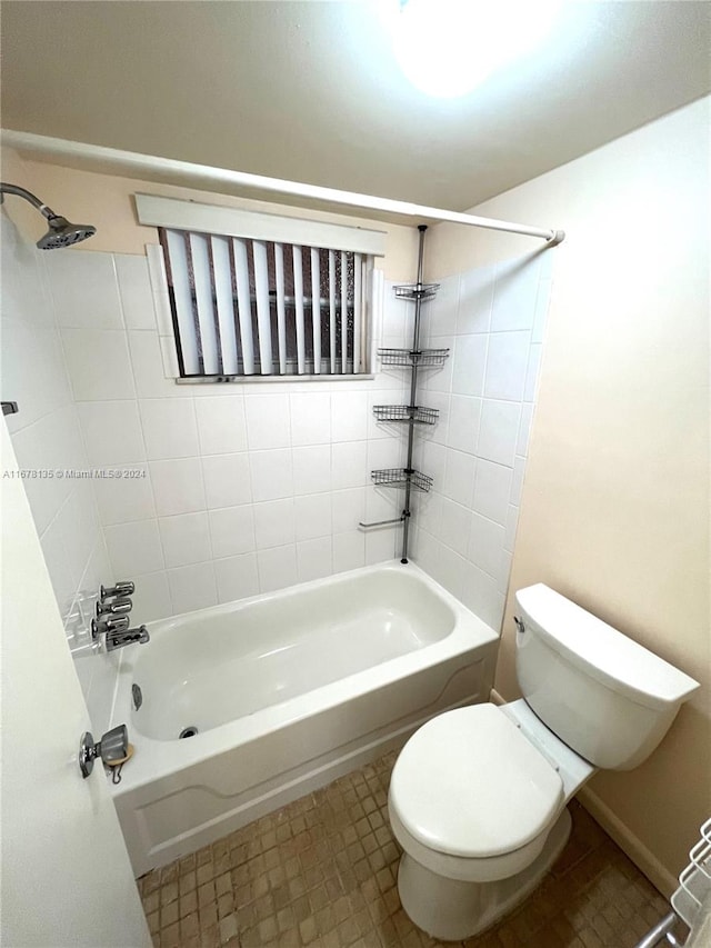 bathroom featuring tiled shower / bath and toilet