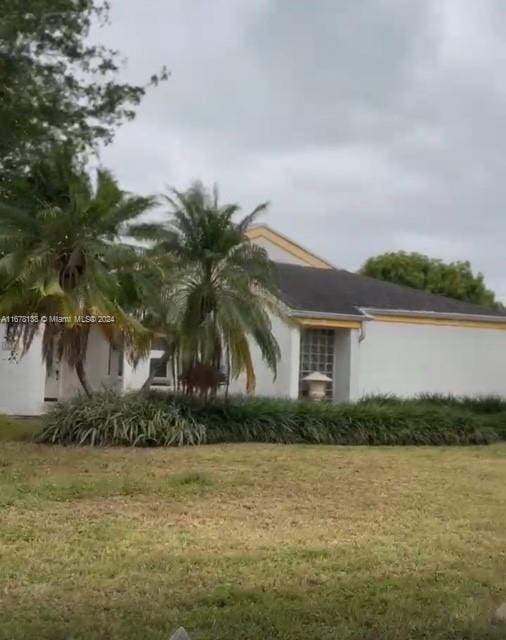 view of side of property with a yard